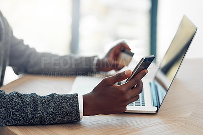 Buy stock photo Shot of an unidentifiable young businessman using wireless technology to make an online purchase in the office