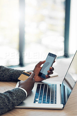 Buy stock photo Shot of an unidentifiable young businessman using wireless technology to make an online purchase in the office