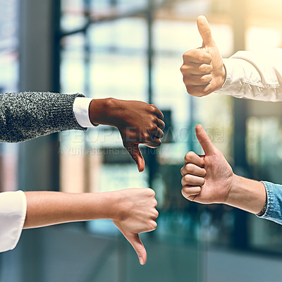 Buy stock photo Cropped shot of a group of unrecognizable businesspeople gesturing thumbs up and down