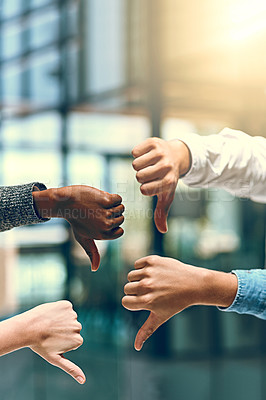 Buy stock photo Cropped shot of a group of unrecognizable businesspeople gesturing thumbs down