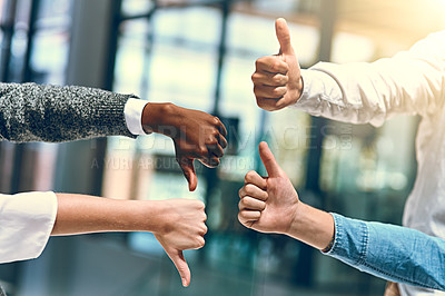 Buy stock photo Cropped shot of a group of unrecognizable businesspeople gesturing thumbs up and down
