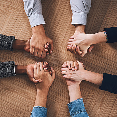 Buy stock photo Above, partnership or business people holding hands for support, teamwork or strategy in office. Motivation, zoom or employees in group collaboration with diversity or mission for goals together