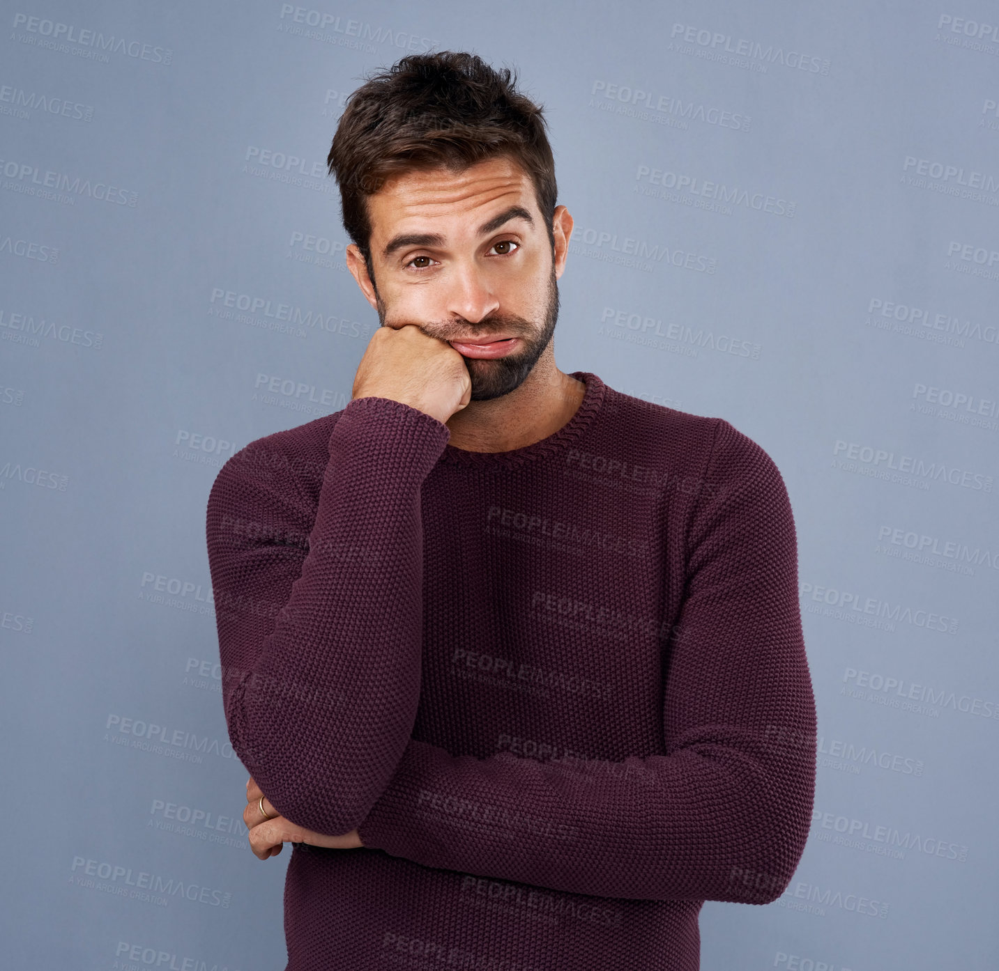 Buy stock photo Studio shot of a handsome young man looking bored against a gray background