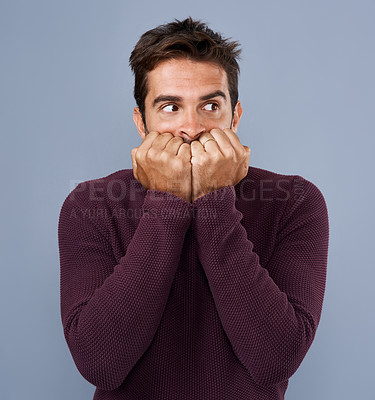 Buy stock photo Worry, afraid and phobia of man in studio, anxiety and biting of nails for stress, scared and fear. Gray background, mockup space and person with terror for nightmare of fail in test of college