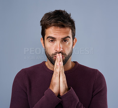 Buy stock photo Portrait, faith and man in studio, praying and hands for miracle of hope, belief or healing gesture. Blue background, praise and respect of God, Christian and person in religion and holy with peace