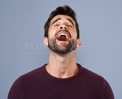 Buy stock photo Studio shot of a handsome young man feeling relieved  against a gray background