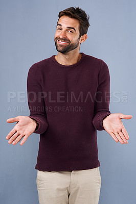 Buy stock photo Studio shot of a handsome young man gesturing in indifference against a gray background