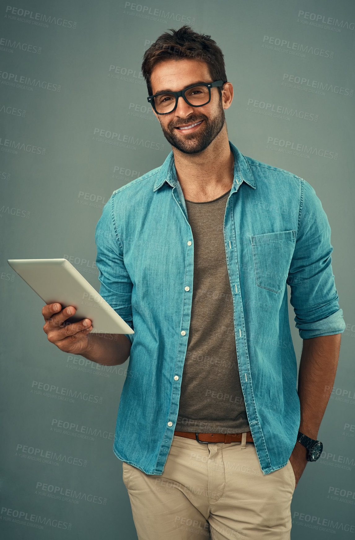 Buy stock photo Man, backdrop and portrait with tablet and glasses, career with software programming in London. Male creative, ebook and studio with happiness for digital job, mobile app or website development