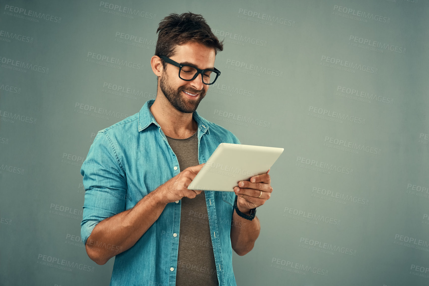 Buy stock photo Man, scroll and tablet by white background with smile for social media, internet or website search. Fashion designer, happy and technology for b2b ecommerce, startup and online or digital catalog