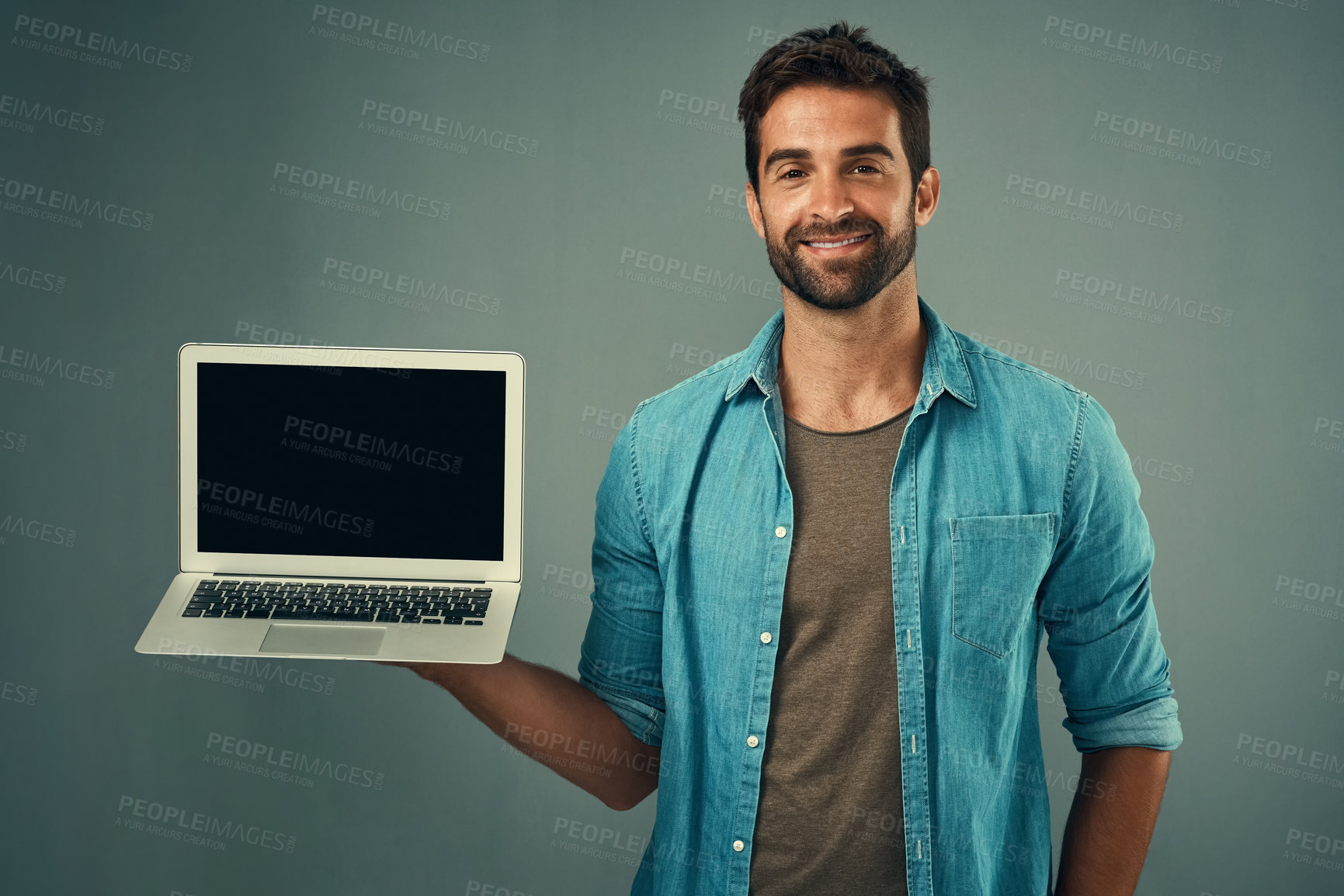 Buy stock photo Happy man, laptop and mockup screen for advertising or marketing against a grey studio background. Portrait of male person with smile showing computer display or mock up space for advertisement