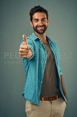 Buy stock photo Happy man, portrait and thumbs up for winning, success or good job against a grey studio background. Male person with smile showing thumb emoji, yes sign or like for approval, thank you or support