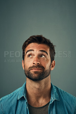 Buy stock photo Man, face and thinking on mockup space for idea, plan or wondering against a grey studio background. Isolated thoughtful male person or model in question, doubt or confused mindset for planning dream
