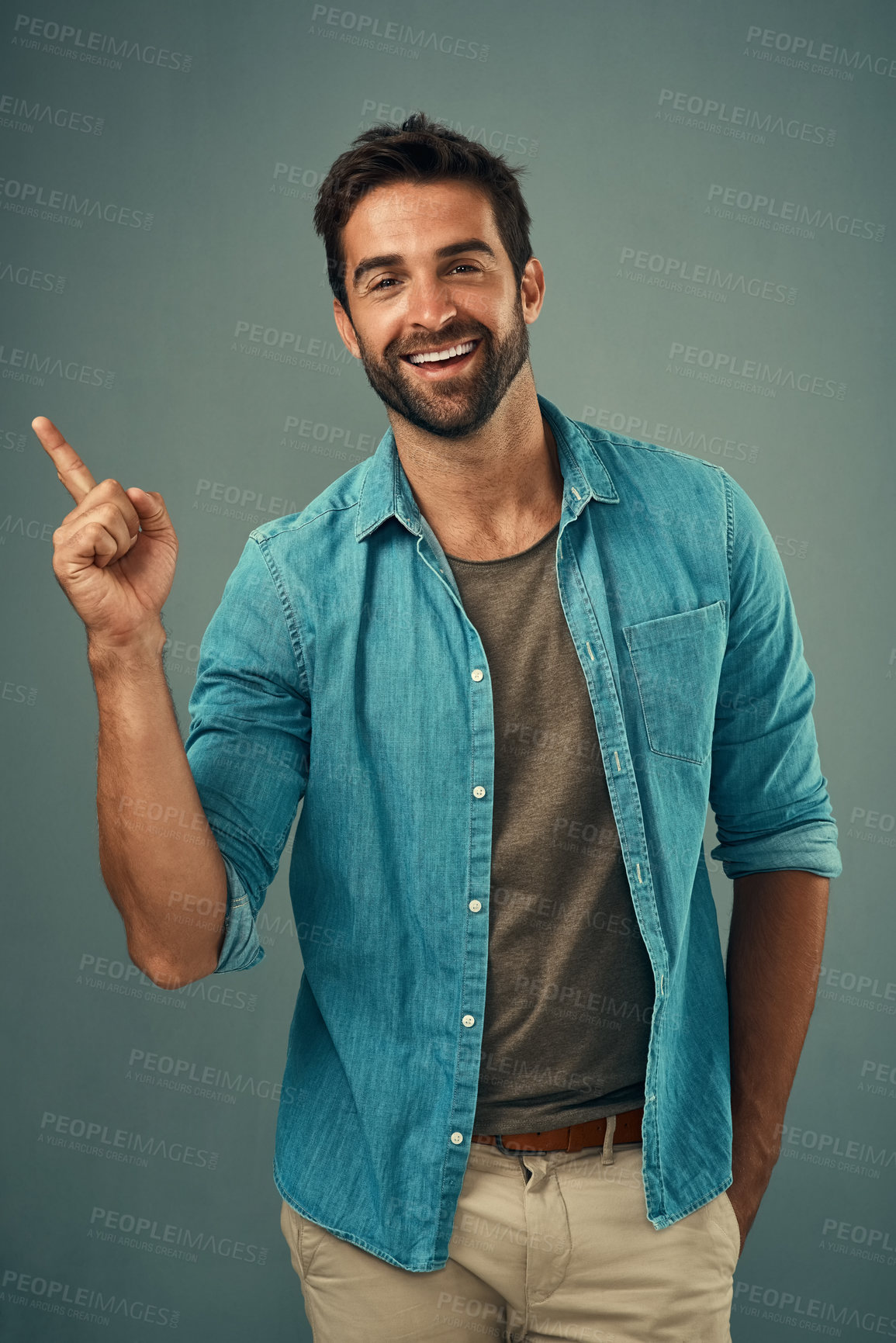 Buy stock photo Point, smile and portrait of happy man in studio on gray background for announcement, news and information. Fashion, mockup space and male person with hand sign for promotion, choice and branding