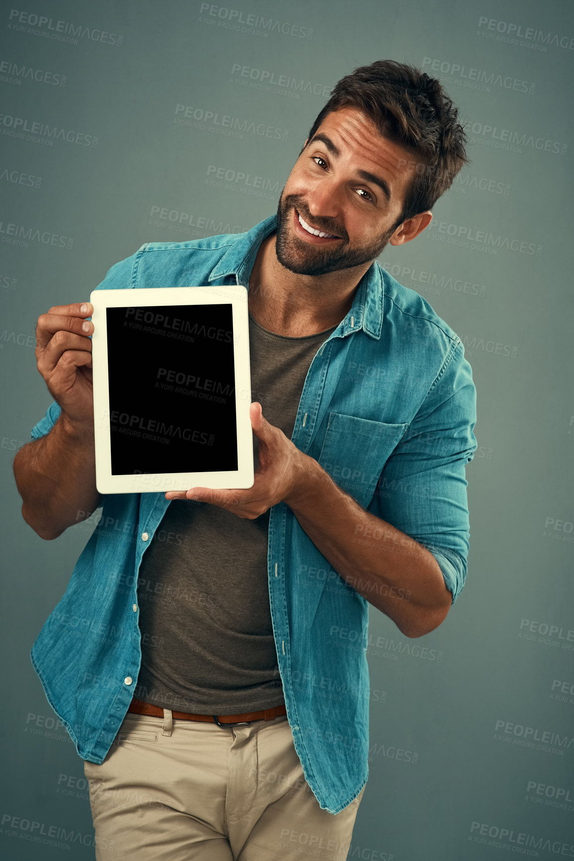 Buy stock photo Happy man, tablet and mockup screen for advertising, marketing or branding against a grey studio background. Portrait of male person showing technology display or mock up space for advertisement