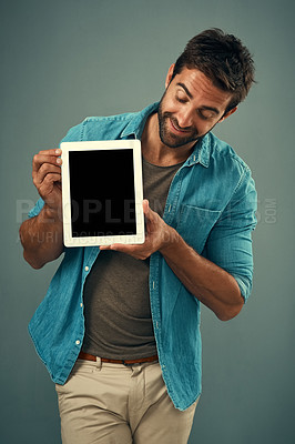 Buy stock photo Man, tablet and mockup screen for advertising, marketing or branding against a grey studio background. Happy male person with smile showing technology display or mock up space for advertisement