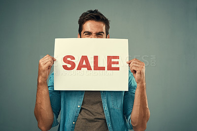Buy stock photo Man, hands and sale sign for advertising, marketing or branding against a grey studio background. Excited male person or model holding billboard or poster for sales, announcement or advertisement