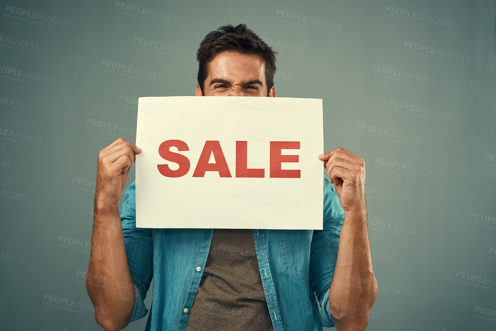 Buy stock photo Man, hands and sale sign for advertising, marketing or branding against a grey studio background. Excited male person or model holding billboard or poster for sales, announcement or advertisement