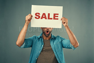 Buy stock photo Man, hands and sale sign for advertising, marketing or branding against a grey studio background. Male person, surprise or discount holding board or poster for sales announcement or advertisement