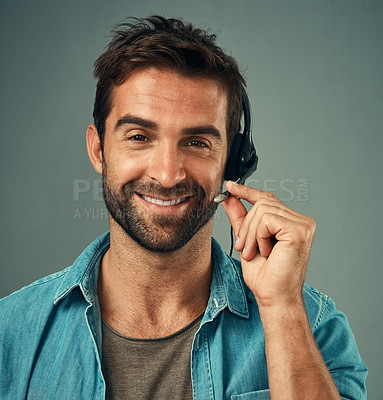 Buy stock photo Happy man, headphones and portrait of a call center consultant against a grey studio background. Face of friendly male consulting agent smiling with headset in contact us, customer service or advice