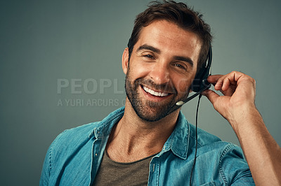 Buy stock photo Happy man, headphones and portrait of call center consultant against a grey studio background. Face of friendly male consulting agent with smile and headset in contact us for help or online advice