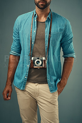 Buy stock photo Fashion, vintage camera and male photographer in studio for stylish clothes, creativity or memory. Inspiration, man or journalist and film for photography, production or lens focus by gray background