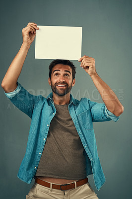 Buy stock photo Happy man, poster and mockup billboard for advertising, marketing or branding against a grey studio background. Male person holding blank shape placard or board for sign, message or advertisement