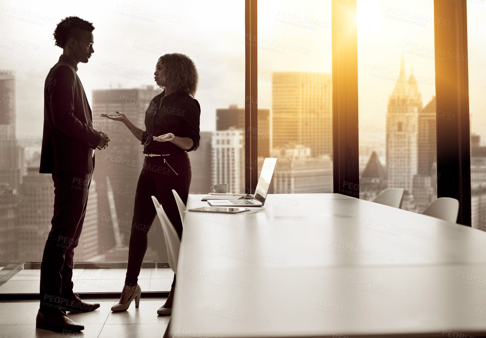 Buy stock photo Shot of two businesspeople having a discussion in an office