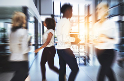 Buy stock photo Shot of businesspeople walking in a busy office