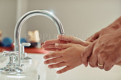 Buy stock photo Cropped shot of an unidentifiable father showing his little girl how to wash her hands