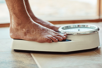 Buy stock photo Cropped shot of an unidentifiable man standing on a bathroom scale