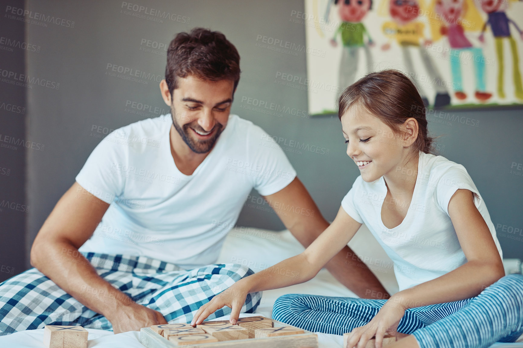 Buy stock photo Shot of a man playing a board game with his little girl at home