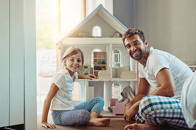 Buy stock photo Shot of an adorable little girl spending time with her father at home