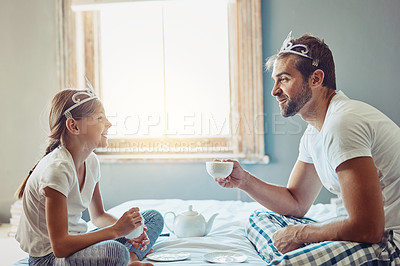 Buy stock photo Shot of a father and daughter having a tea party at home