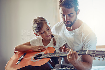 Buy stock photo Father with daughter, guitar with teaching and learning at home, bonding with love and creativity. Family, man and girl learn to play musical instrument, lesson and music education with talent