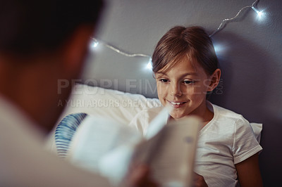 Buy stock photo Cropped shot of a father reading a bedtime story to his little girl