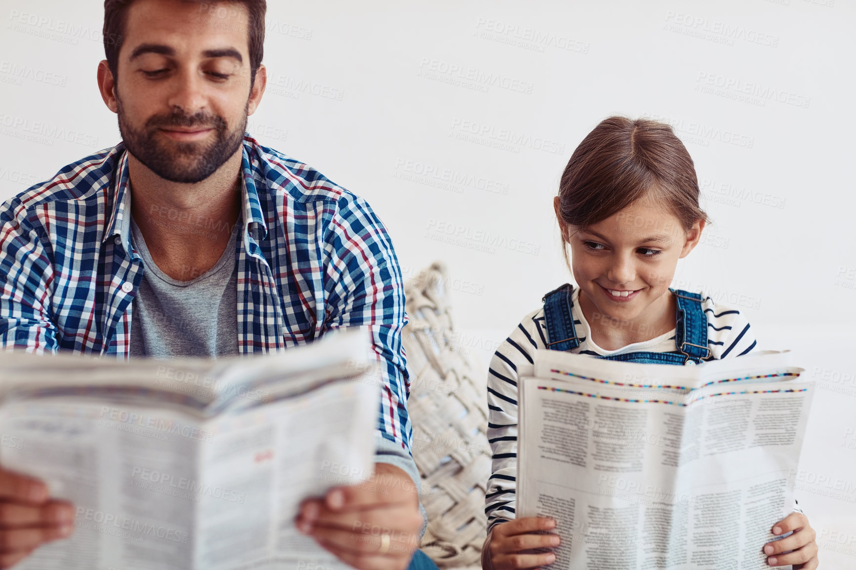 Buy stock photo Shot of an adorable little girl spending time with her father at home