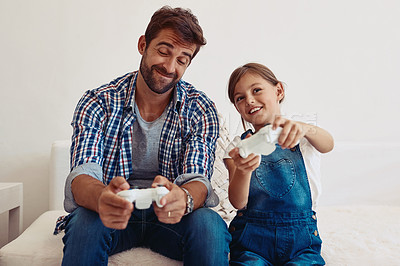 Buy stock photo Cropped shot of a father and his daughter playing video games at home