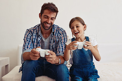 Buy stock photo Cropped shot of a father and his daughter playing video games at home