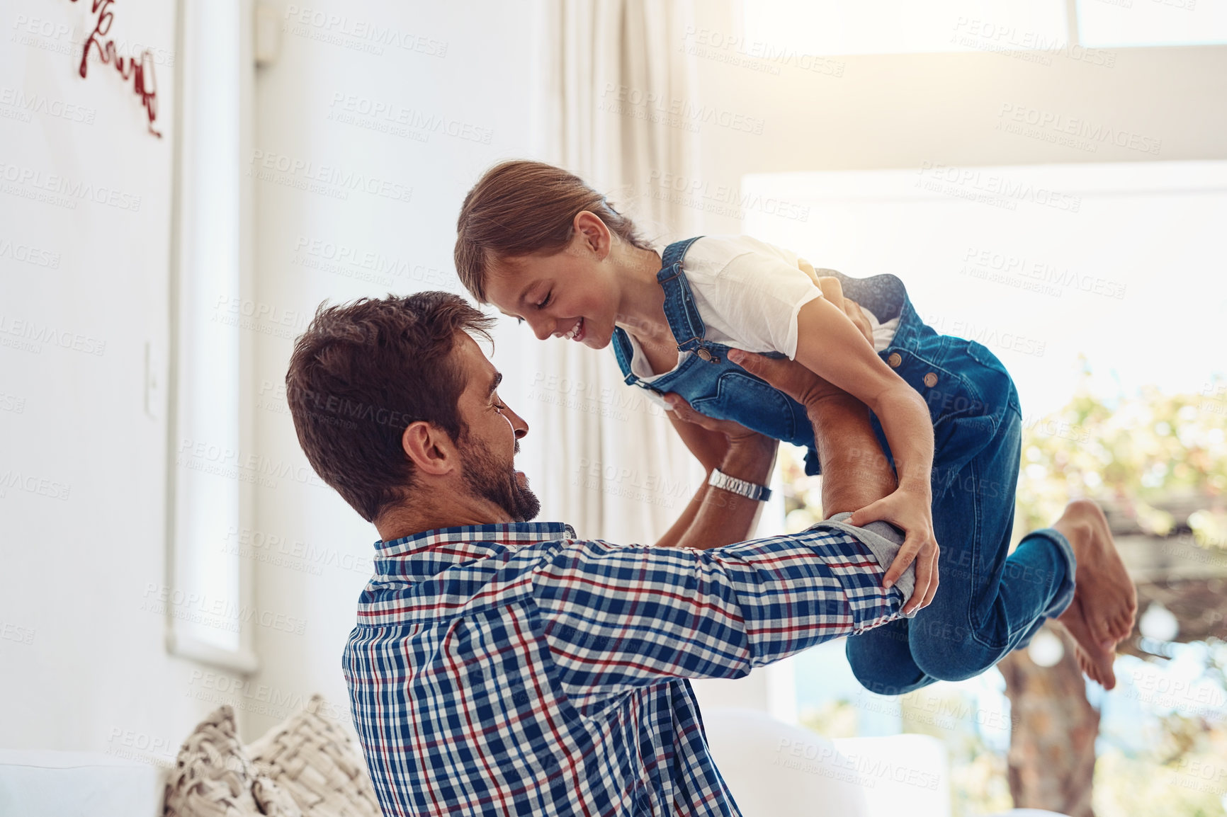 Buy stock photo Father, girl child and playing in home for bonding, fun activity and game with energy or trust in living room. People, parent and daughter with balance in house for support, care and love in lounge