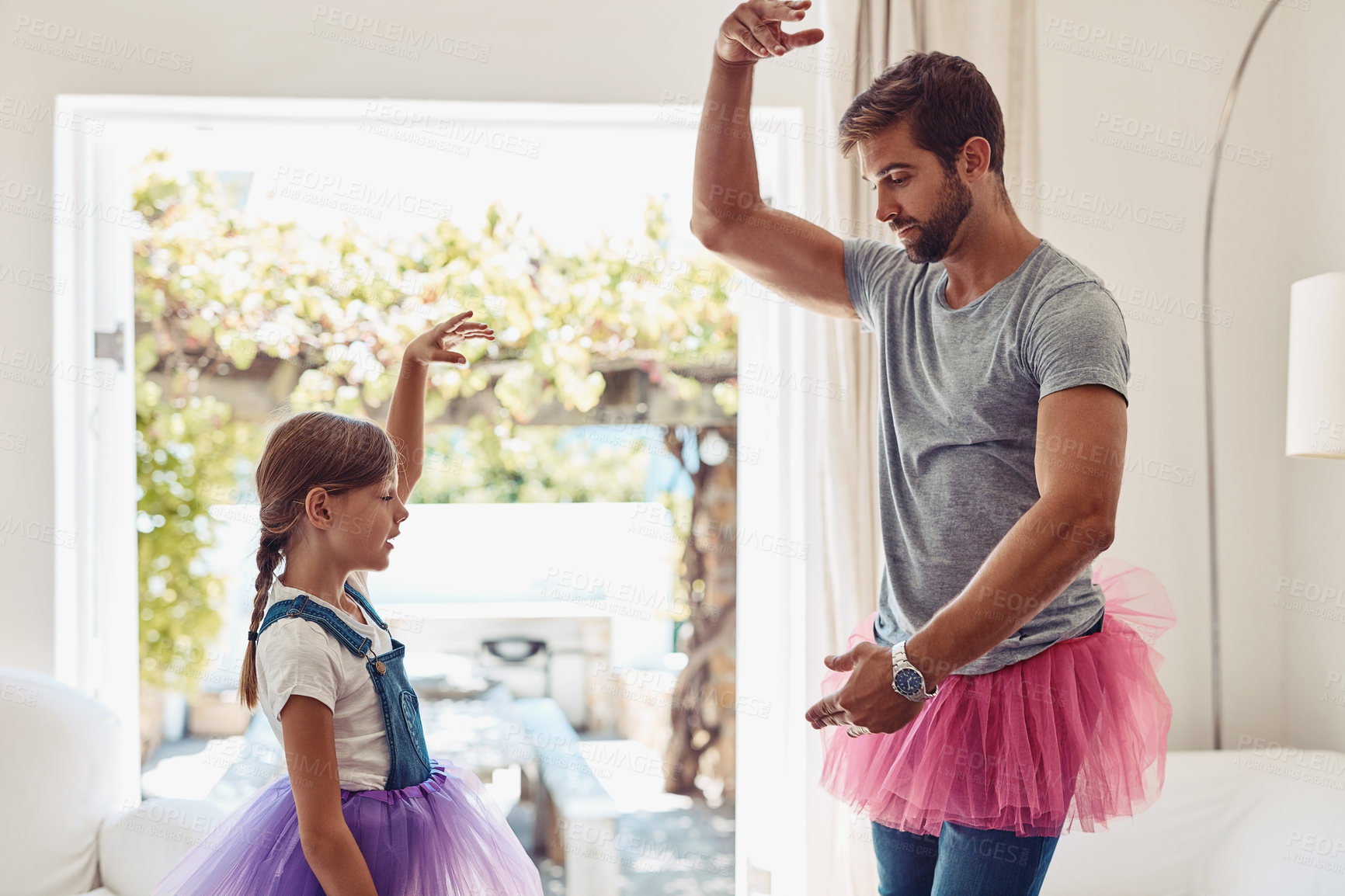 Buy stock photo Shot of a father and daughter dancing in their tutus