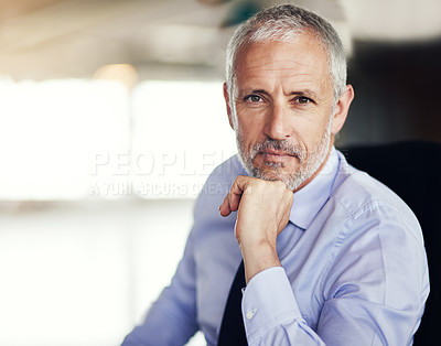 Buy stock photo Cropped portrait of a handsome and mature businessman sitting in his office