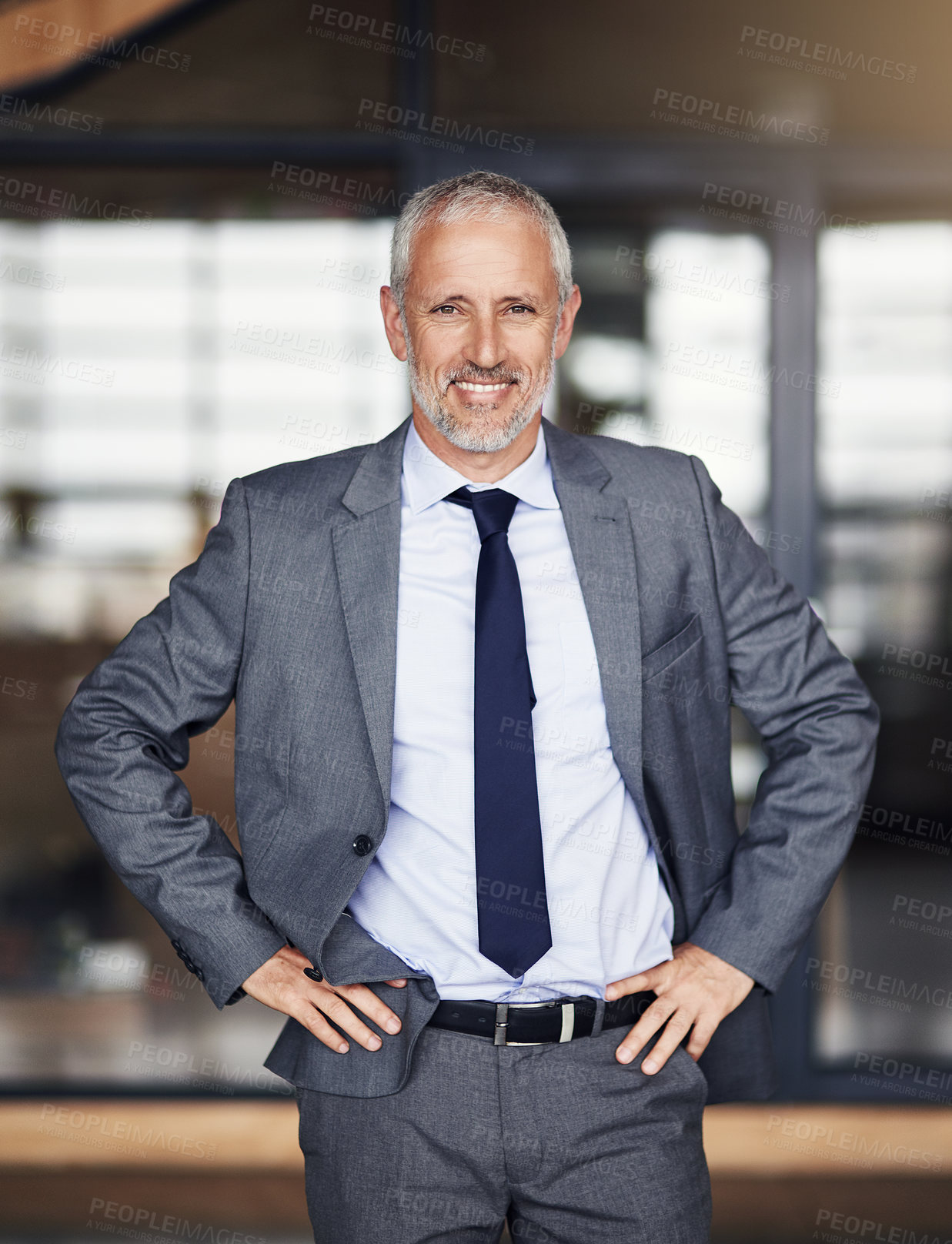 Buy stock photo Cropped portrait of a mature businessman standing with his hands on his hips