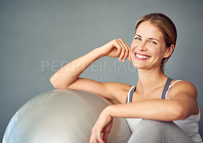 Buy stock photo Cropped portrait of an attractive mature woman sitting next to an exercise ball
