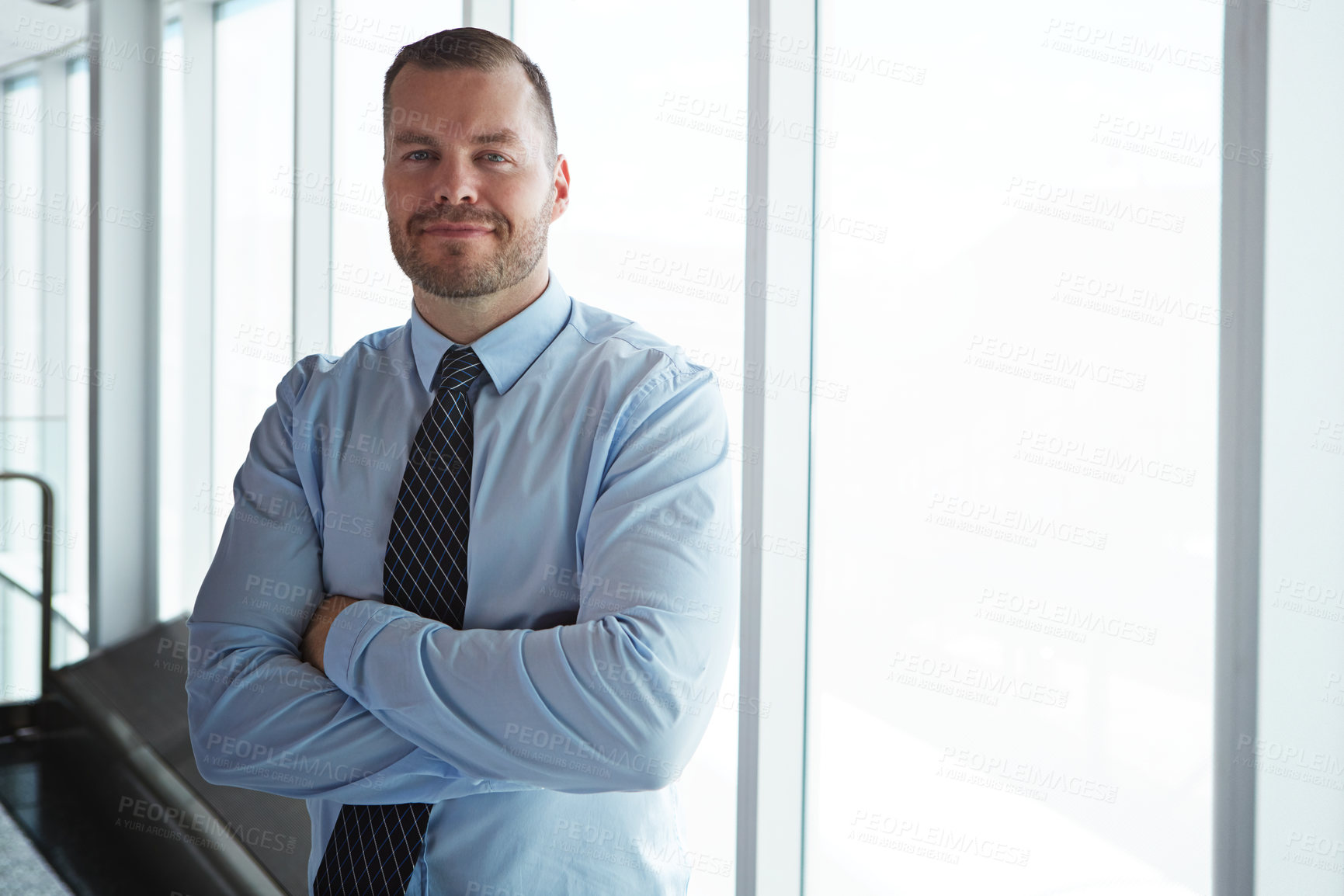 Buy stock photo Arms crossed, portrait and window with business man in office for career development or pride. About us, ambition and space with happy corporate employee in workplace for opportunity or satisfaction