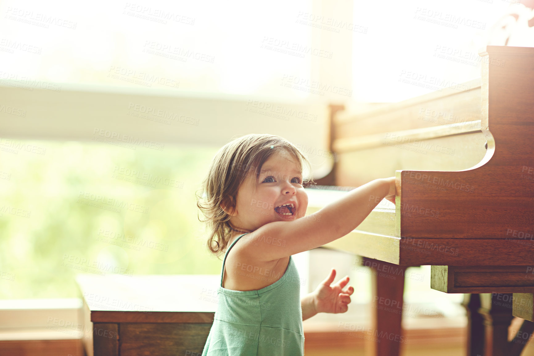 Buy stock photo Girl, toddler and playing on piano in home for musical development, learning and growth of motor skills or creativity. Child, instrument and playful in house for entertainment, education and sound.