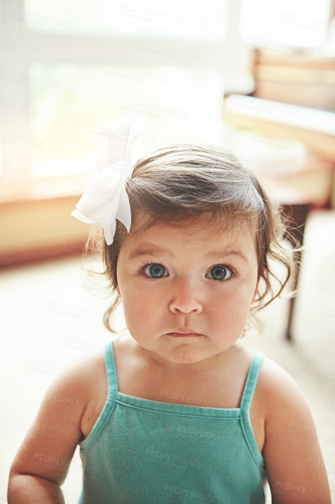 Buy stock photo Portrait, child and cute girl in home for growth, childhood development and innocent in house. Serious, toddler and adorable kid in apartment on weekend, wellness and peace with calm in Sweden