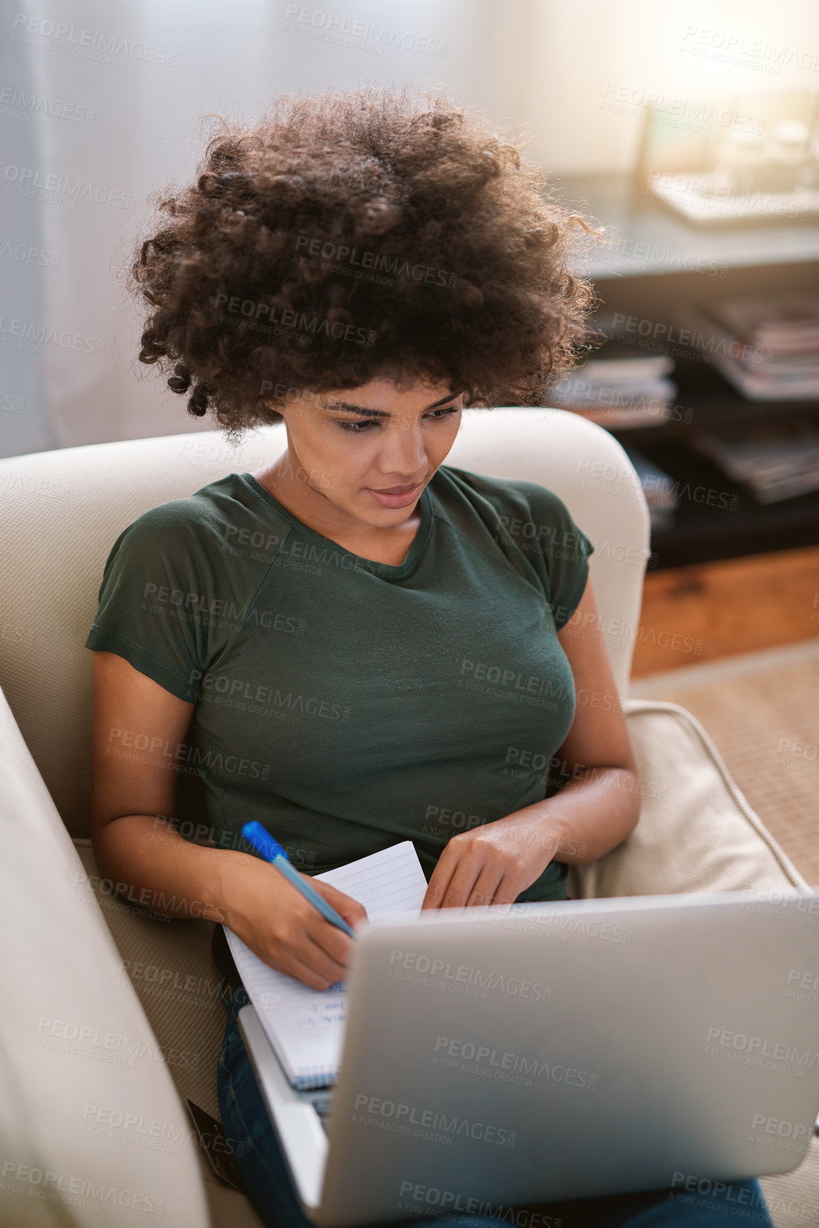 Buy stock photo Cropped shot of a woman using her laptop on the sofa at home
