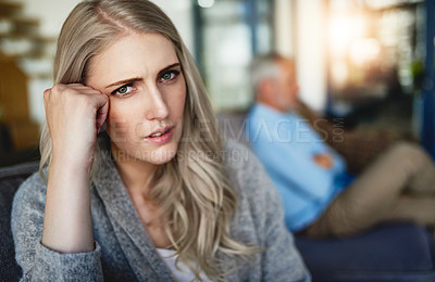 Buy stock photo Portrait of a woman looking despondent after having a fight with her husband at home