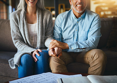 Buy stock photo Holding hands, happy  senior couple and life insurance support with paperwork in a living room. Home, sofa and elderly people with empathy, hope and trust with solidarity for investment in a lounge
