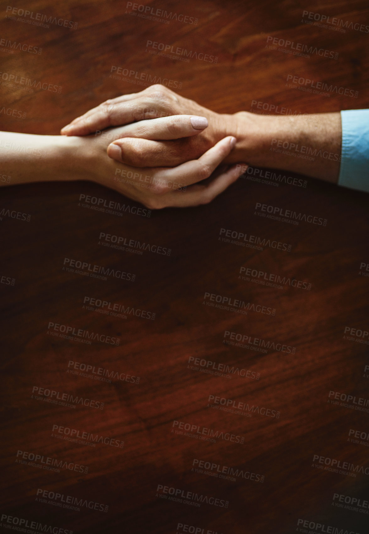 Buy stock photo Closeup shot of two unidentifiable people holding hands in comfort